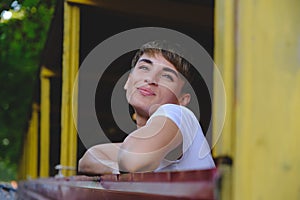 Portrait of female hipster with natural makeup and short haircut enjoying leisure time outdoors