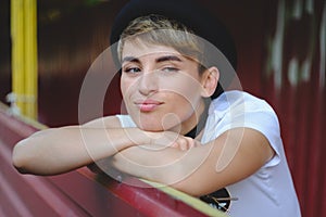 Portrait of female hipster with natural makeup and short haircut enjoying leisure time outdoors