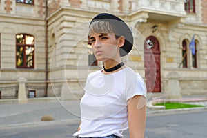 Portrait of female hipster with natural makeup and short haircut enjoying leisure time outdoors