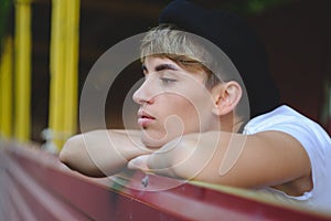 Portrait of female hipster with natural makeup and short haircut enjoying leisure time outdoors