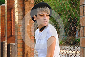 Portrait of female hipster with natural makeup and short haircut enjoying leisure time outdoors