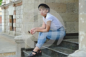 Portrait of female hipster with natural makeup and short haircut enjoying leisure time outdoors