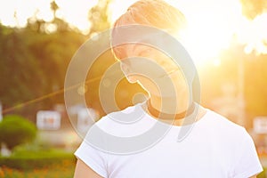 Portrait of female hipster with natural makeup and short haircut enjoying leisure time outdoors