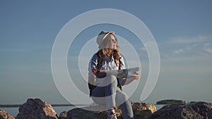 Portrait of female hipster who smiles at the sun and dreams travel