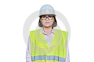 Portrait of female industrial worker in protective helmet vest on white background