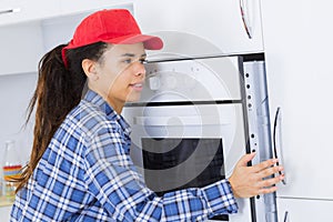 portrait female inserting fitted oven