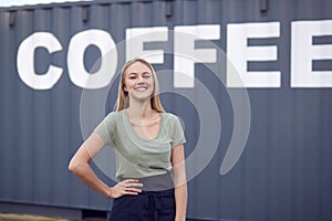 Portrait Of Female Intern At Freight Haulage Business Standing By Shipping Container 