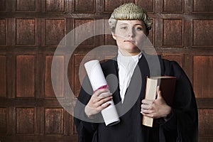Portrait Of Female Lawyer In Court Holding Brief And Book