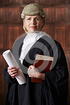 Portrait Of Female Lawyer In Court Holding Brief And Book