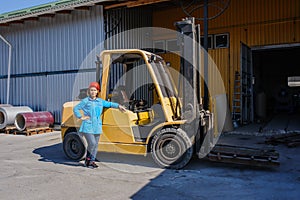 Portrait of Female Lift Truck Driver In Factory