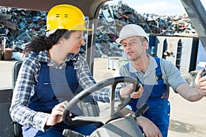 portrait female lift truck driver in factory outdoor