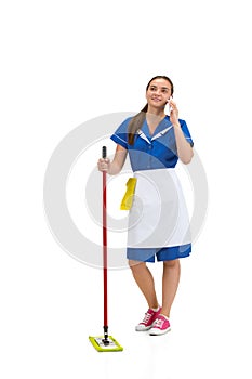 Portrait of female made, cleaning worker in white and blue uniform isolated over white background