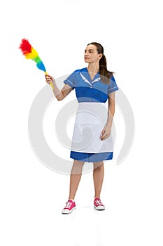 Portrait of female made, cleaning worker in white and blue uniform isolated over white background