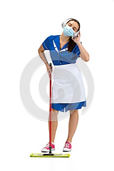 Portrait of female made, cleaning worker in white and blue uniform isolated over white background