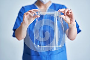 Portrait of female medical doctor wearing protective mask and face shield