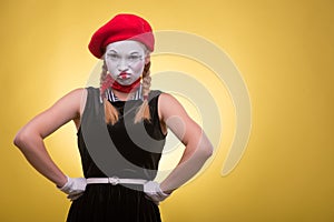 Portrait of female mime isolated on yellow