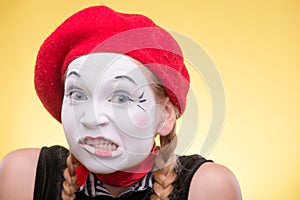 Portrait of female mime isolated on yellow