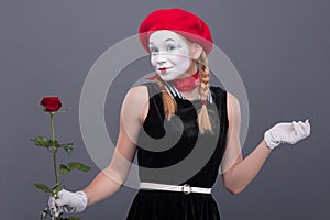 Portrait of female mime with red hat and white