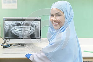 Portrait of female muslim dentist working in dental clinic, teeth check-up and Healthy teeth concept