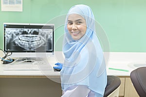 Portrait of female muslim dentist working in dental clinic, teeth check-up and Healthy teeth concept