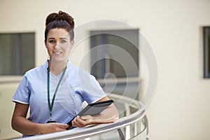 Portrait Of Female Nurse With Digital Tablet In Hospital