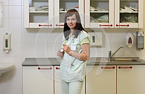 Portrait female nurse in ICU in green uniform.