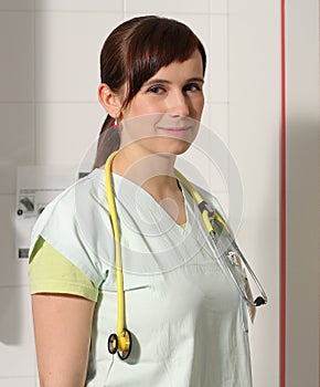 Portrait female nurse in ICU in green uniform.