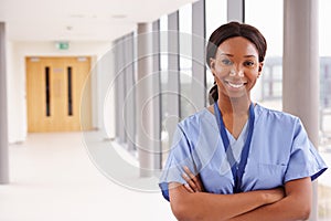 Portrait Of Female Nurse Standing In Hospital Corridor