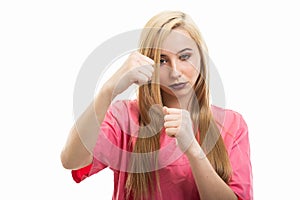 Portrait of female nurse wearing scrubs holding fists like fighting