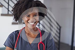 Portrait Of Female Nurse Wearing Scrubs In Hospital