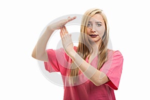 Portrait of female nurse wearing scrubs making time out gesture