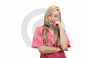 Portrait of female nurse wearing scrubs standing like thinking