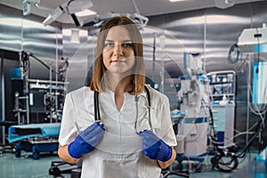 Portrait of female nurse in white uniform and stethoscope in operating room in hospital.