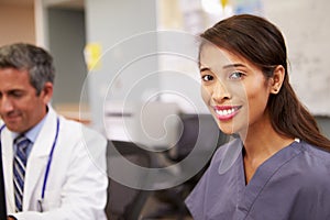 Portrait Of Female Nurse Working At Nurses Station