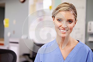 Portrait Of Female Nurse Working At Nurses Station