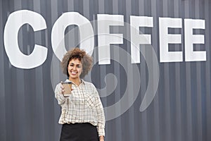 Portrait Of Female Owner Of Coffee Shop Or Distribution Business Standing By Shipping Container