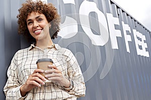 Portrait Of Female Owner Of Coffee Shop Or Distribution Business Standing By Shipping Container