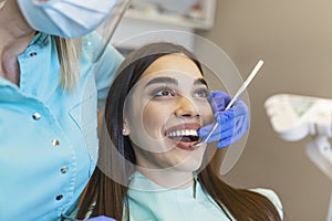 Portrait of female patient having treatment at dentist.Dentist examining a patient`s teeth in dentist office