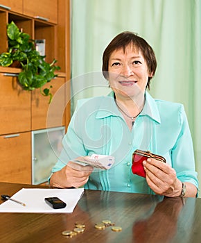 Portrait of female pensioner with cash and bills
