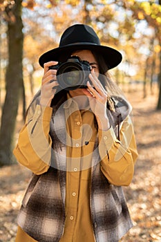 Portrait of a female photographer with a SLR camera in her hands. Photography and hobby