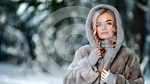 Portrait of female posing in luxury natural fur coat outdoor. Shot on RED Raven 4k Cinema Camera