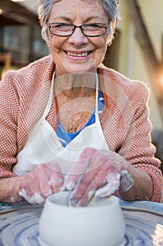 Portrait of female potter making pot