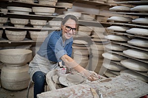 Portrait of female potter molding a clay