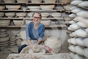 Portrait of female potter molding a clay