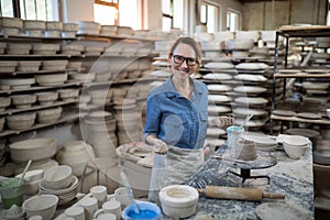 Portrait of female potter molding a clay