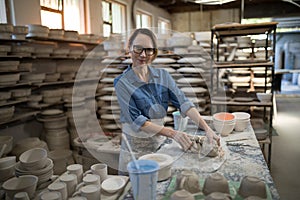 Portrait of female potter molding a clay