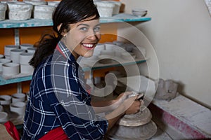 Portrait of female potter molding a clay