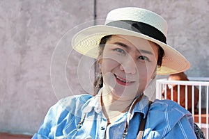 Portrait of female protrait in white hat and looking away.