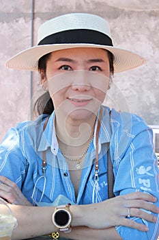 Portrait of female protrait in white hat and looking away.