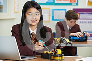 Portrait Of Female Pupil In Science Lesson Studying Robotics